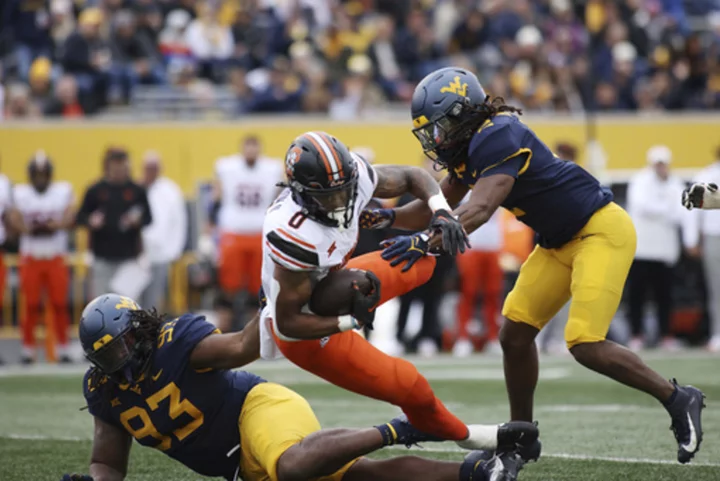 Gordon romps for 282 yards, 4 TDs, Oklahoma State outlasts West Virginia 48-34