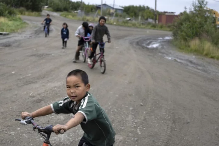 Children in remote Alaska aim for carnival prizes, show off their winnings and launch fireworks